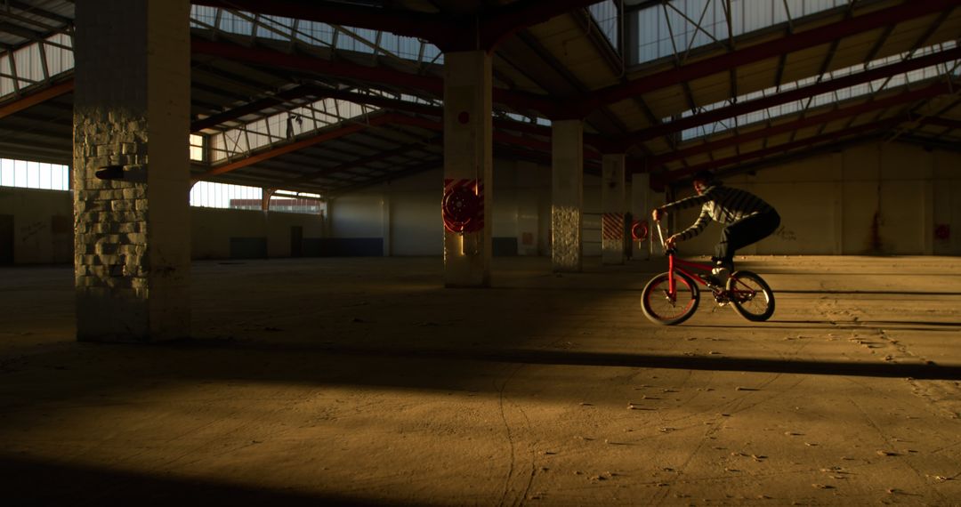 Rider Performing Tricks Inside Abandoned Warehouse - Free Images, Stock Photos and Pictures on Pikwizard.com