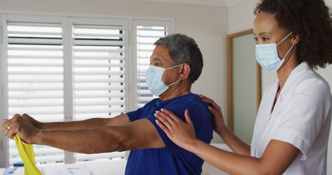 Physical Therapist Assisting Elderly Patient with Arm Exercise - Free Images, Stock Photos and Pictures on Pikwizard.com