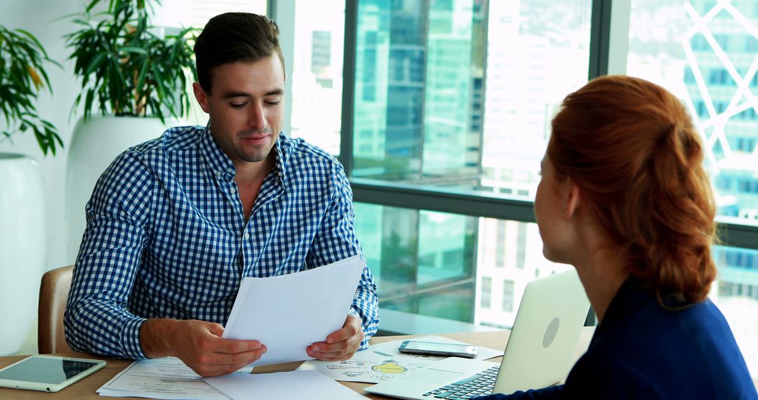 Business Partner Reviewing Documents in Modern Office Collaboration