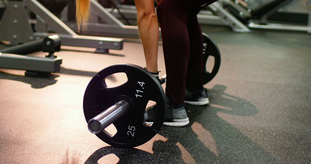 Muscular woman lifting barbell in modern gym - Free Images, Stock Photos and Pictures on Pikwizard.com