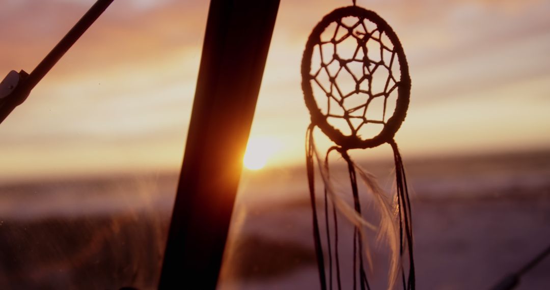 Dreamcatcher Hanging from Car Window During Sunset - Free Images, Stock Photos and Pictures on Pikwizard.com