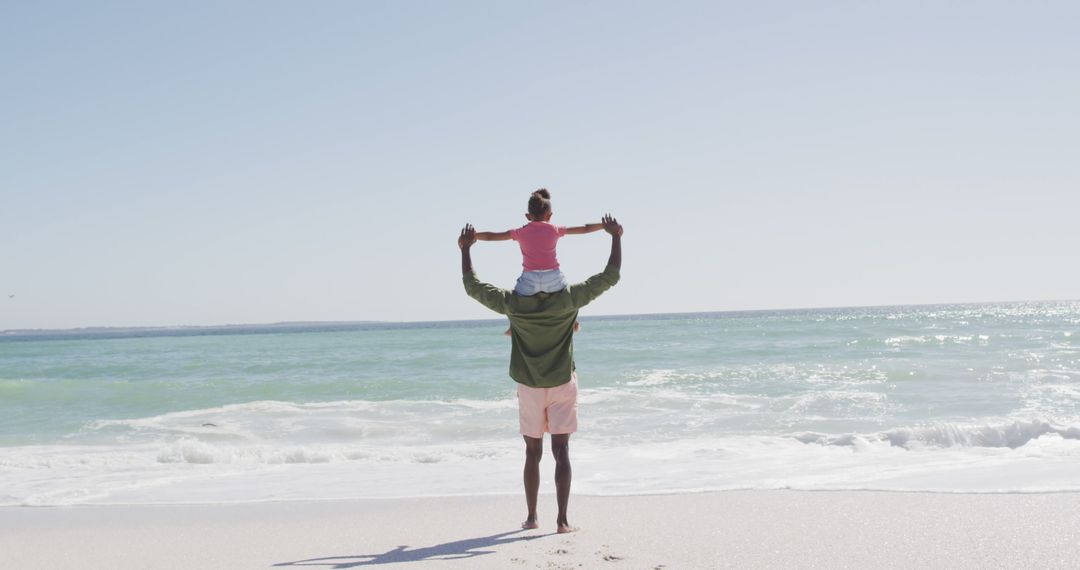 Father Carrying Daughter on Shoulders at Beach - Free Images, Stock Photos and Pictures on Pikwizard.com