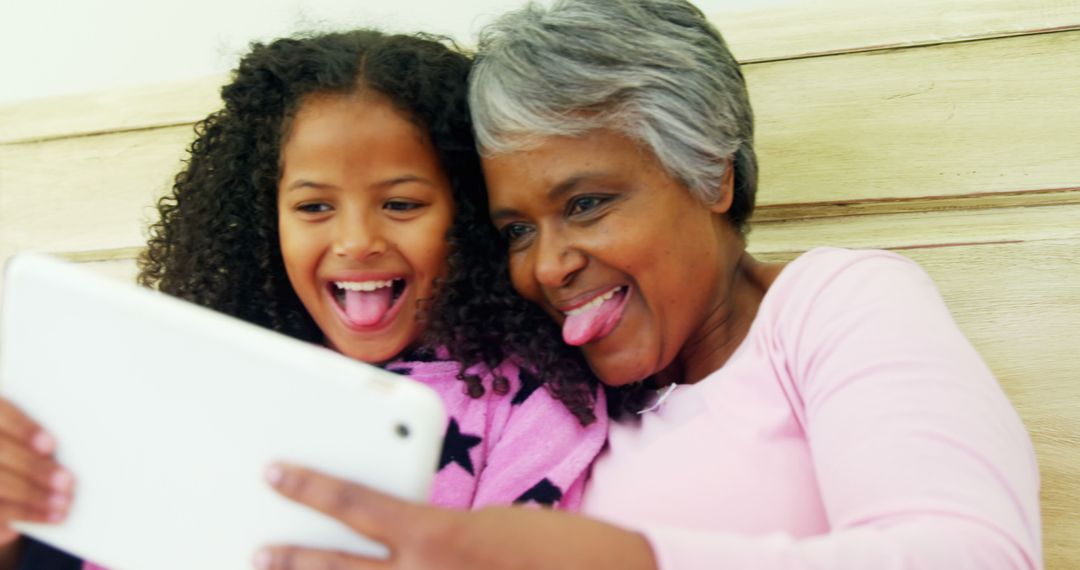 Grandmother and Granddaughter Enjoying Tablet Together - Free Images, Stock Photos and Pictures on Pikwizard.com