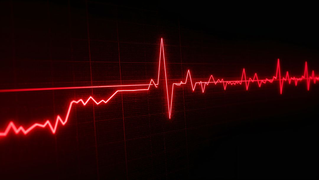 Vibrant Red Medical Monitor Showing Heartbeat Waveform on Dark Grid