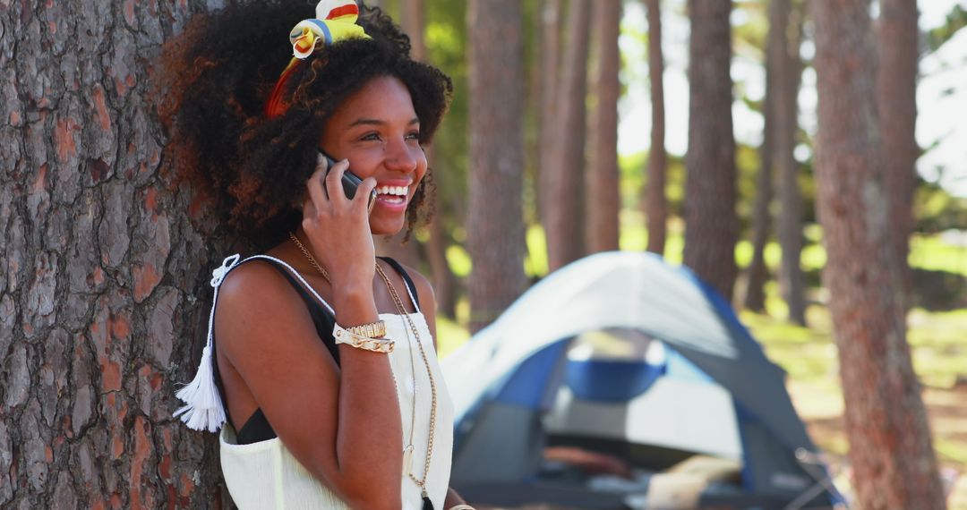 Young Woman Enjoying a Phone Call While Camping in a Forest - Free Images, Stock Photos and Pictures on Pikwizard.com