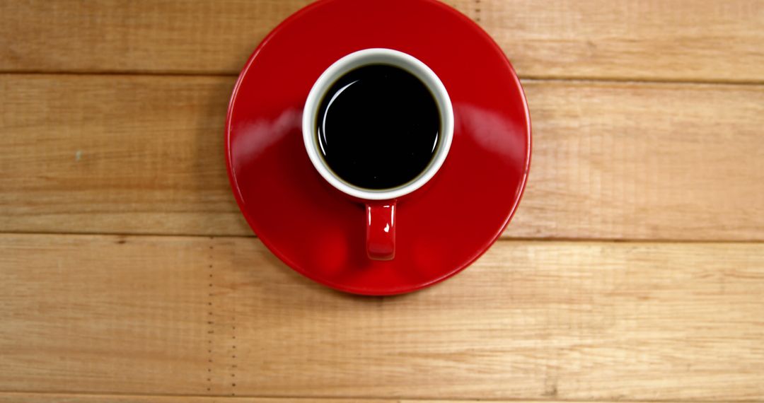 Top View of Black Coffee in Red Cup on Wooden Table - Free Images, Stock Photos and Pictures on Pikwizard.com