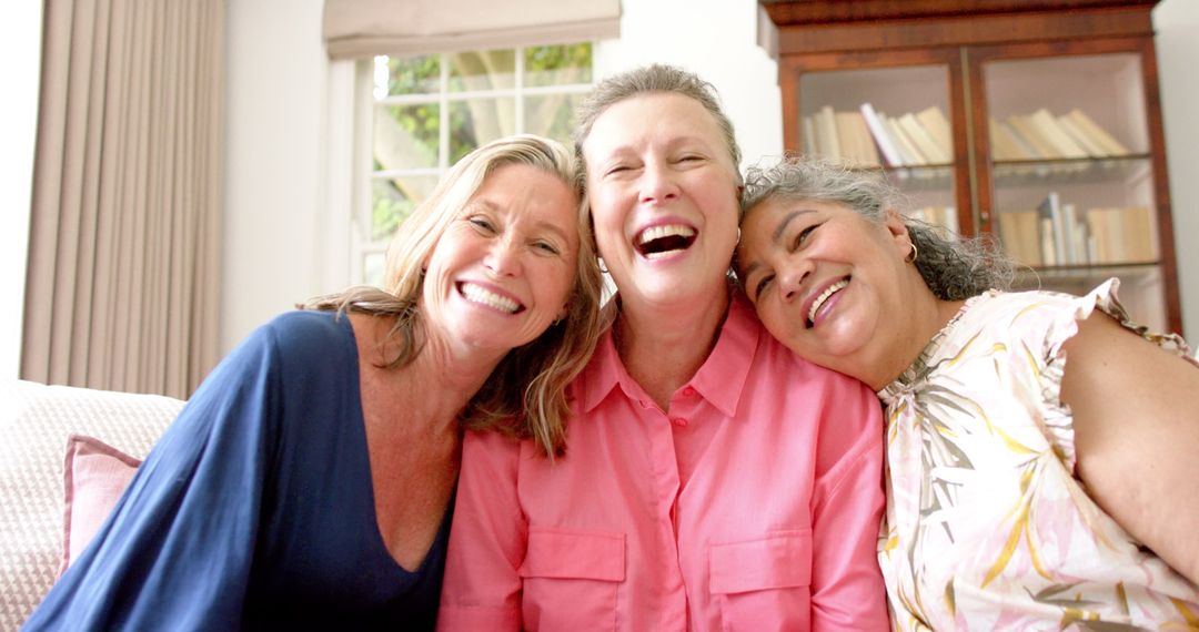 Joyful Senior Friends Laughing Together at Home