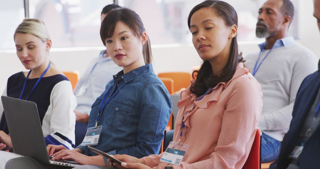 Diverse Colleagues Engaged in Meeting with Technology