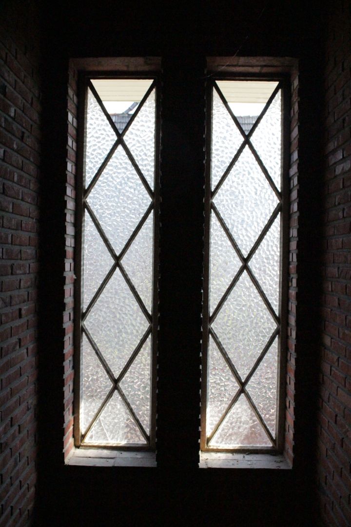 Sunlit Lattice Windows in Brick Wall - Free Images, Stock Photos and Pictures on Pikwizard.com