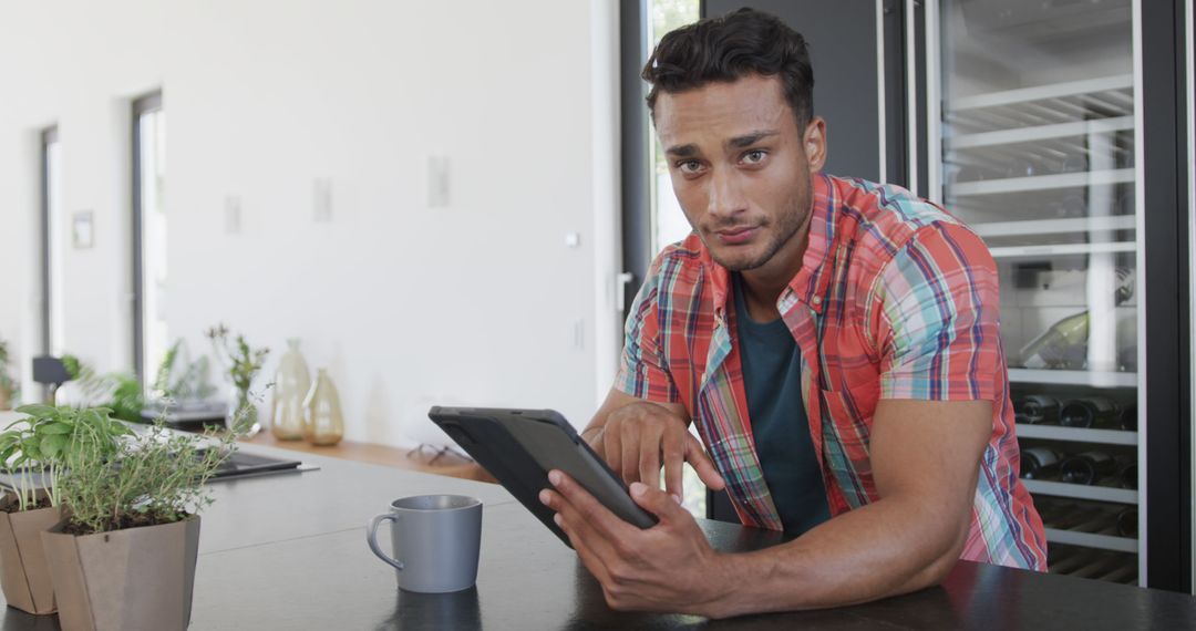 Young Man Using Digital Tablet with Coffee at Home - Free Images, Stock Photos and Pictures on Pikwizard.com