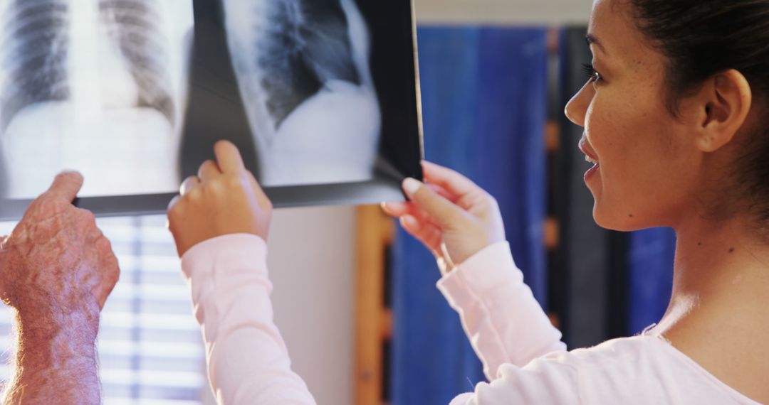 Doctor and Patient Examining X-Ray Scan Together - Free Images, Stock Photos and Pictures on Pikwizard.com