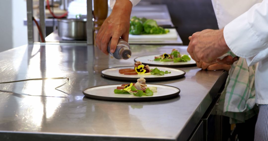 Chefs plating gourmet dishes with precision in professional kitchen - Free Images, Stock Photos and Pictures on Pikwizard.com