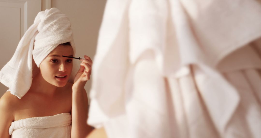 Woman Applying Mascara in Bathroom Mirror - Free Images, Stock Photos and Pictures on Pikwizard.com