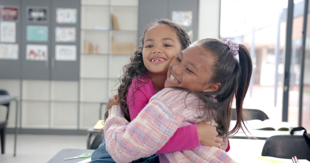 Girls Embracing Joyful Friendship in Classroom Environment