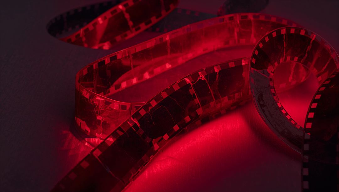 Red-Illuminated 35mm Film Negative on Dim Surface