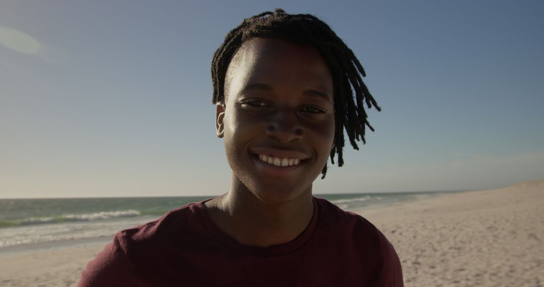 Smiling Man on Serene Beach During Daytime