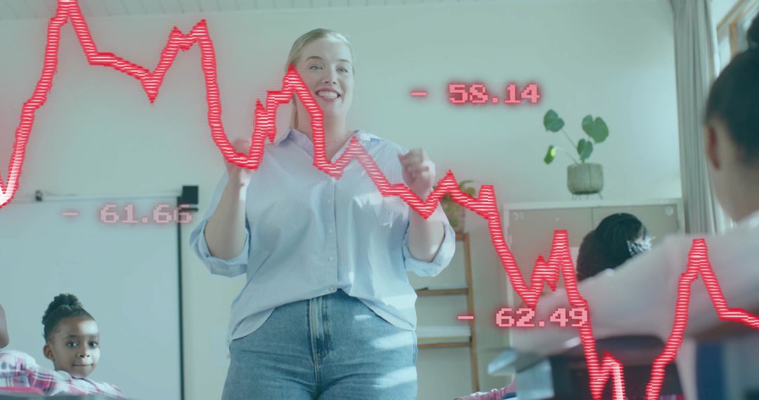 Female teacher presenting lesson with declining red graph overlay in classroom