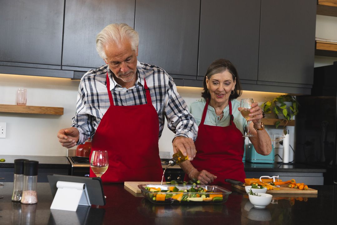 Senior Couple Culinary Enjoyment with Vegetables and Wine in Modern Kitchen