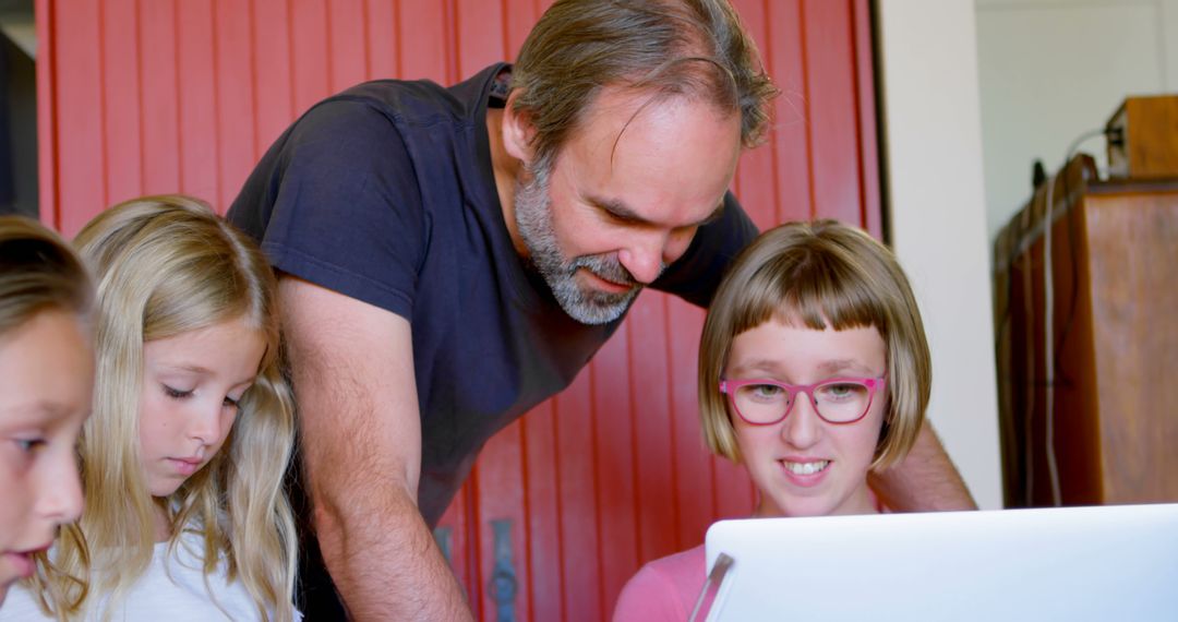 Teacher assisting young students with laptop in classroom - Free Images, Stock Photos and Pictures on Pikwizard.com