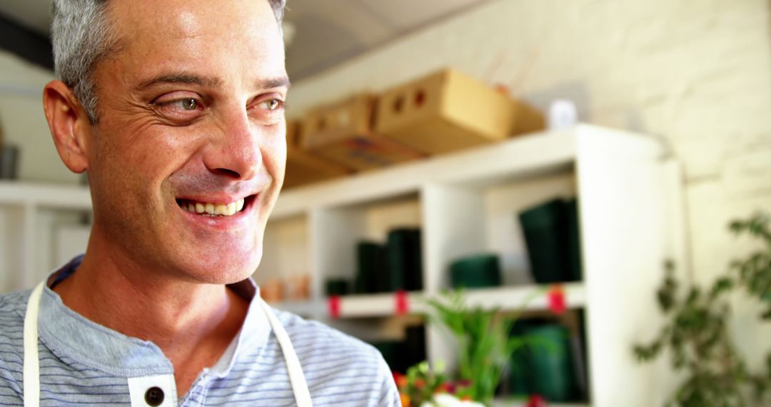 Smiling Florist in Flower Shop with Shelves in Background - Free Images, Stock Photos and Pictures on Pikwizard.com