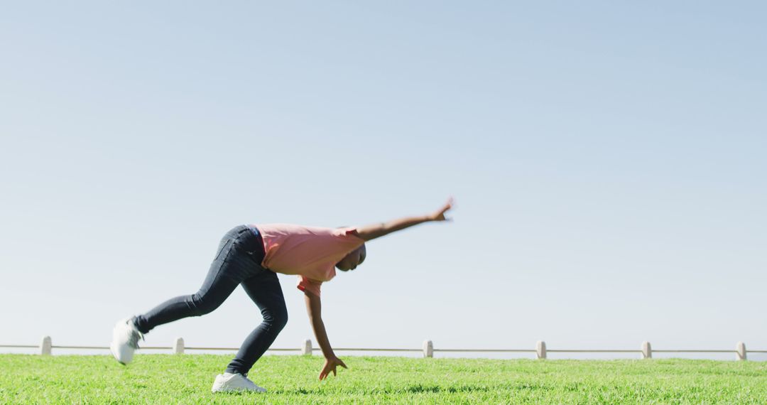 Youthful Joy: Boy Performing Cartwheel in Open Field - Free Images, Stock Photos and Pictures on Pikwizard.com