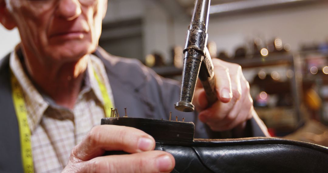 Shoemaker hammering on a shoe in workshop 4k - Free Images, Stock Photos and Pictures on Pikwizard.com