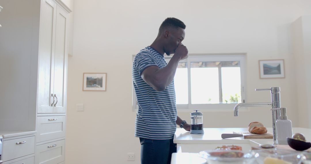 Man Preparing Morning Coffee in Modern White Kitchen - Free Images, Stock Photos and Pictures on Pikwizard.com