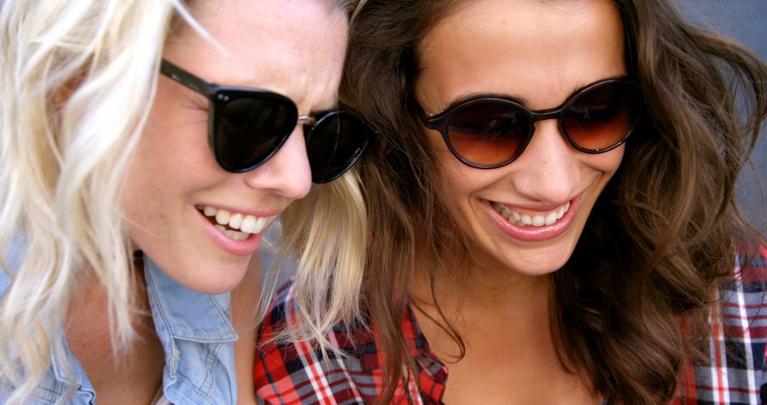 Female Friends Smiling in Sunglasses Outdoors - Free Images, Stock Photos and Pictures on Pikwizard.com