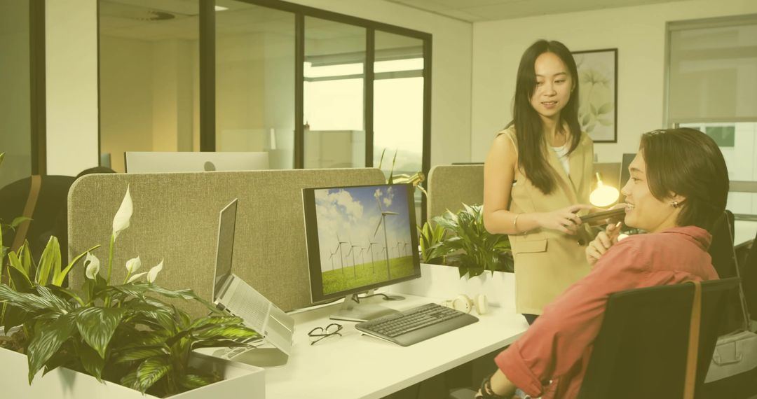 Coworkers Discussing Project at Modern Eco-Friendly Workspace