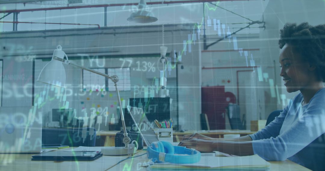 Businesswoman Analyzing Financial Data on Laptop with Digital Graph Overlay