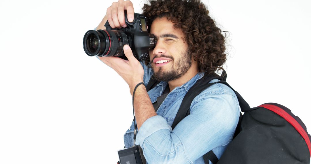 Curly-haired Photographer with Camera and Backpack - Free Images, Stock Photos and Pictures on Pikwizard.com