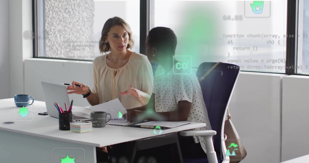 Two Businesswomen Collaborating at Modern Office Desk Discussing Documents