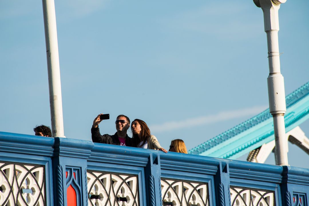 Tourists Taking Selfie on Bridge with Ornate Rails - Free Images, Stock Photos and Pictures on Pikwizard.com