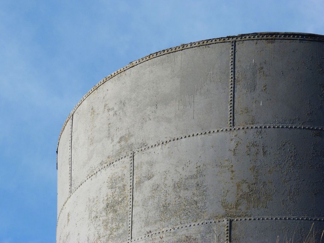 Close-Up of Rusted Water Tower Against Blue Sky - Free Images, Stock Photos and Pictures on Pikwizard.com