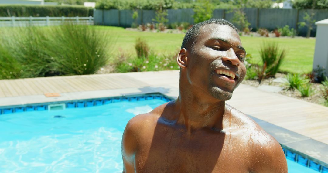 Joyful Young Man Relaxing by Swimming Pool on Sunny Day - Free Images, Stock Photos and Pictures on Pikwizard.com