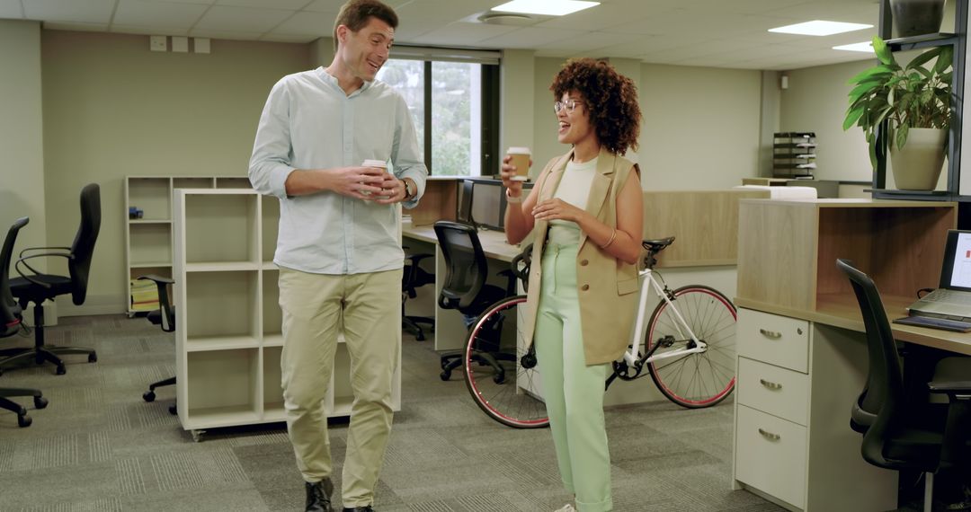 Diverse Coworkers Engaging in Conversation at Modern Open-Plan Office