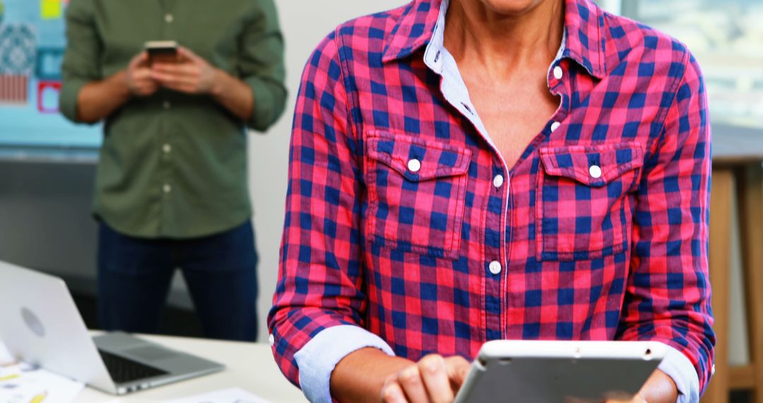 Business Professionals Using Digital Devices in Modern Office