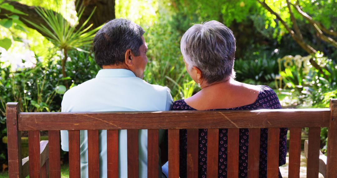 Senior Couple Relaxing on Bench in Sunny Garden - Free Images, Stock Photos and Pictures on Pikwizard.com