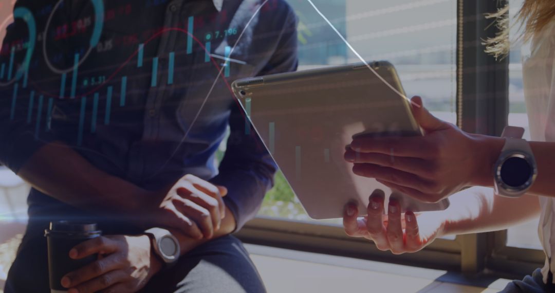 Diverse Coworkers Discussing Business Graph on Tablet