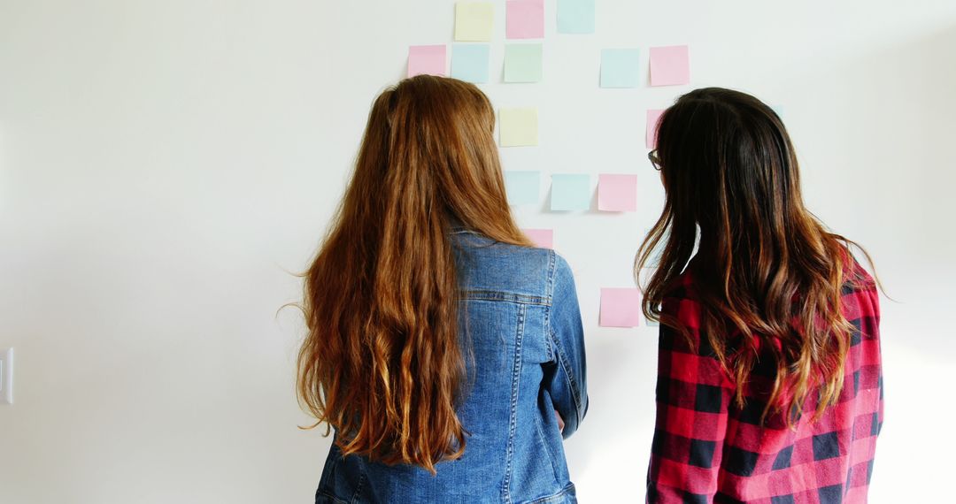 Women Collaborating with Sticky Notes in Office Concept