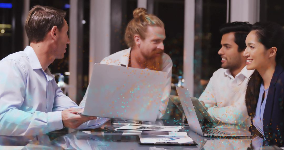 Team Collaboration in Modern Office at Night with Technology