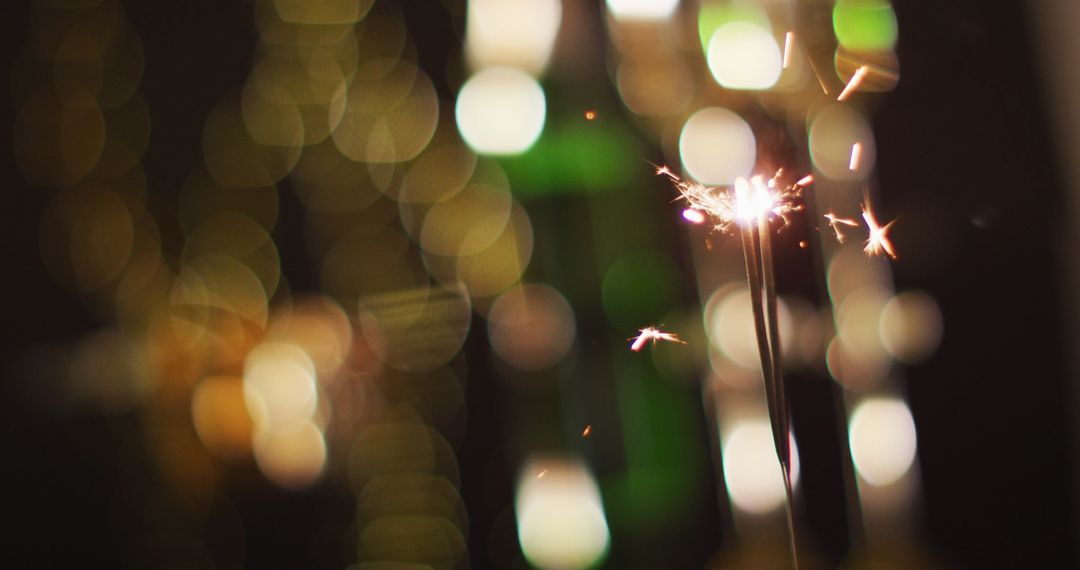 Glowing Sparkler Creating Festive Atmosphere with Bokeh Lights