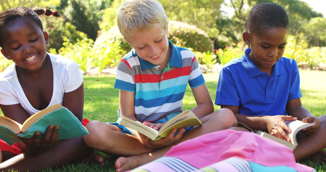 Smiling Children Reading Books Outside on Green Lawn - Free Images, Stock Photos and Pictures on Pikwizard.com