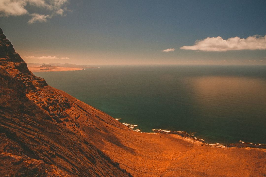 Stunning Coastal Cliffs Overlooking Ocean under Clear Sky - Free Images, Stock Photos and Pictures on Pikwizard.com