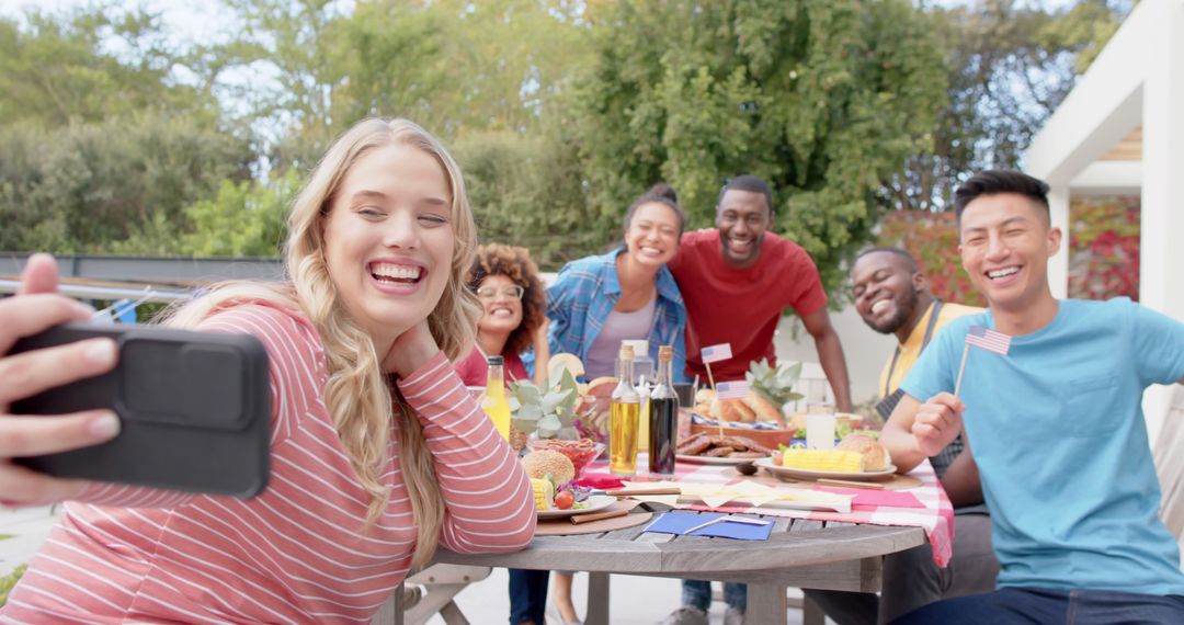 Diverse Friends Taking Cheerful Selfie at Garden Picnic Table - Free Images, Stock Photos and Pictures on Pikwizard.com