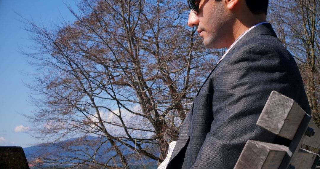 Businessman Working Outdoors on Laptop during Sunny Day - Free Images, Stock Photos and Pictures on Pikwizard.com