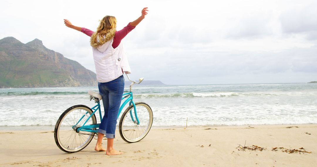 Woman Enjoying Ocean View with Bicycle at Beach - Free Images, Stock Photos and Pictures on Pikwizard.com