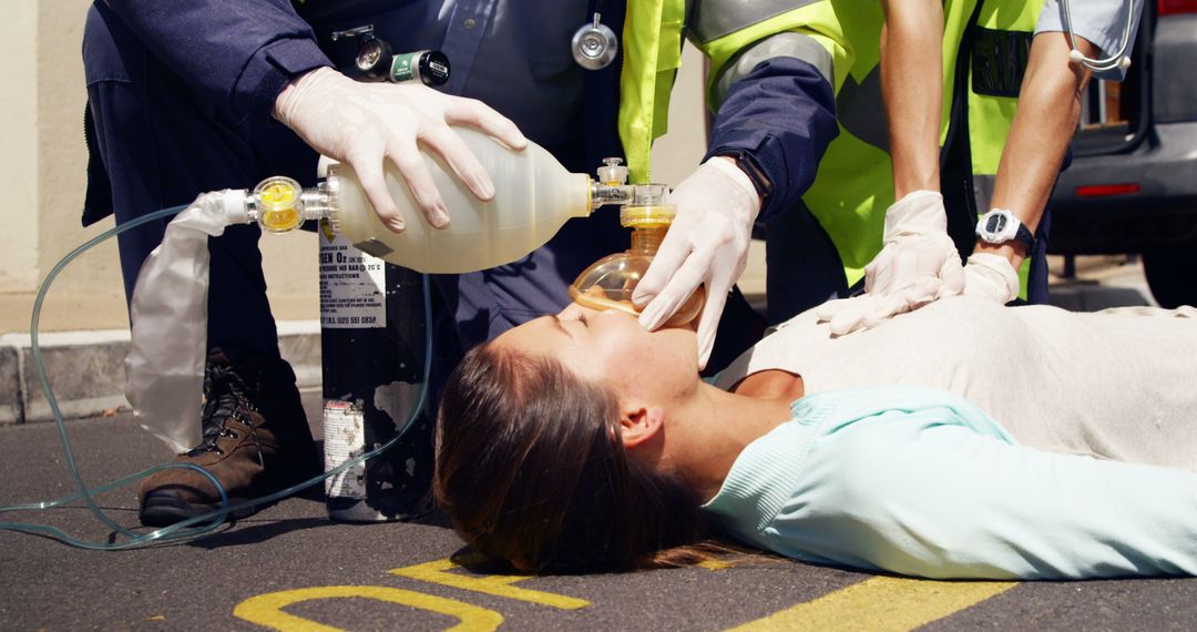 Emergency Personnel Performing CPR and Using Oxygen Bag on Woman - Free Images, Stock Photos and Pictures on Pikwizard.com