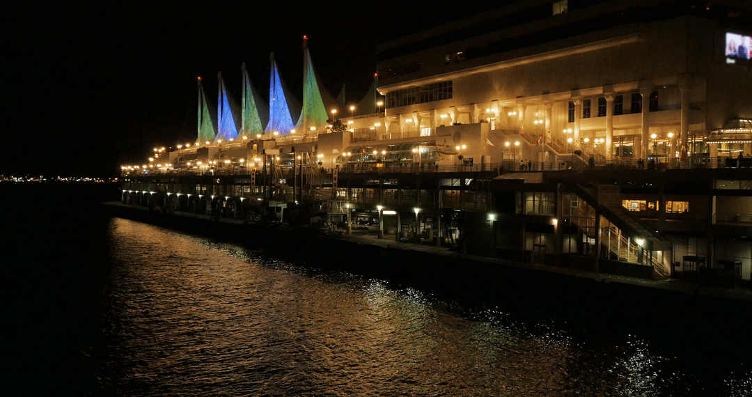 Transparent Night Cityscape with Illuminated Building by River