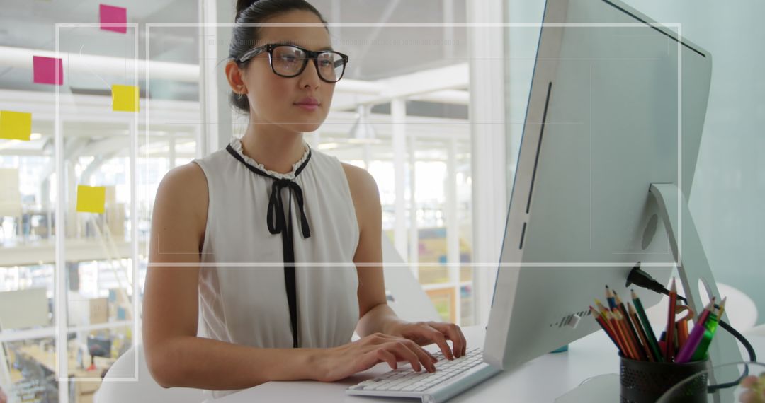 Focused Businesswoman Analyzing Financial Data on Computer